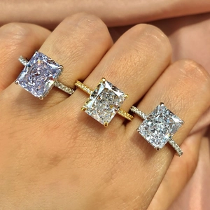 Detailed view of square ice-cut zircons on silver and gold S925 sterling silver rings