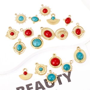 Detail of 18K gold plated stainless steel sunburst pendants with red and turquoise stones