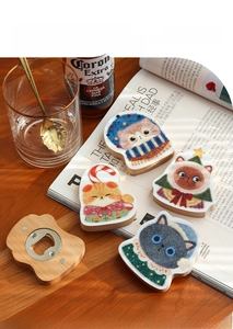 Detail of Christmas cat wooden bottle openers with beech wood base and steel opener