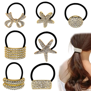 Set of 8 black elastic hair ties featuring gold metal accents and sparkling rhinestones