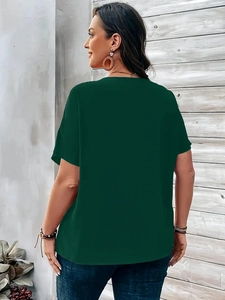Back view of elegant dark green V-neck short sleeve shirt on model with modern wall background