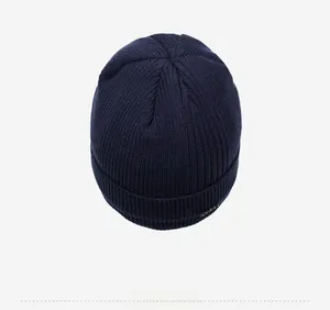 Top view of navy blue ribbed knit beanie showing thick texture and folded cuff