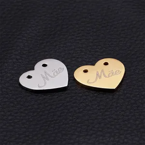 Polished stainless steel heart-shaped pendants with Mae engraving in gold and silver