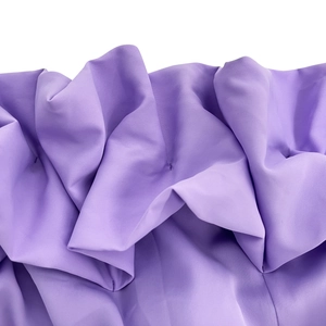 Detail of purple dress featuring delicate pleated ruffles and fine plain weave fabric