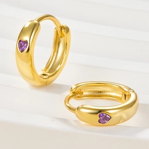 Elegant gold-tone hoop earrings featuring heart-shaped purple cubic zirconia gems
