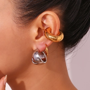 Hammered gold ear cuff and teardrop silver earrings set on model for women