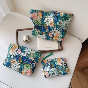 Detailed set of three floral cotton storage bags with artistic pleated patterns