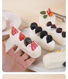 Macro shot of realistic PU foam dessert models featuring faux strawberries and cherries