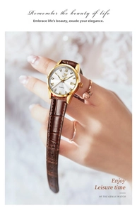 Close-up of OLEVS quartz watch featuring a gold steel case and brown leather strap on wrist