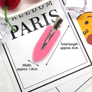 Detail showing 6cm matte pink hair clip with silver metal closure on white card