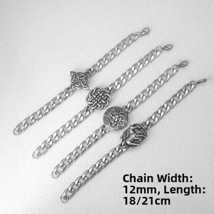 Macro detail of 12mm stainless steel curb chains with Celtic knot and wolf head pendants