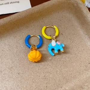 Asymmetric gold earrings with colorful enamel elephant and pumpkin charms on round hoops