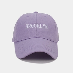 Close-up of white Brooklyn letter embroidery on a lavender cotton baseball cap