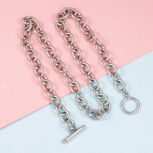 Silver stainless steel OT toggle clasp chain necklace on a pastel bicolour background