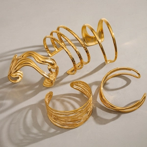 Irregular textured gold open bangles in various multilayer and minimalist metal designs