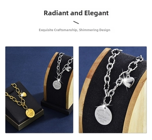 Detail of gold and silver chunky chain necklaces with heart and round eternal love charms