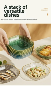 Detail of stacked hammered glass snack plates with gold rims for table snacks