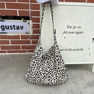 Detailed view of the leopard print canvas tote bag featuring black and white pattern textures