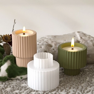Detailed view of striped resin candle jar molds in pink, green, and white colors