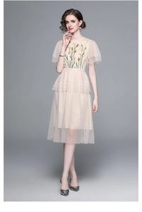Detail of floral embroidery and layered mesh tulle on this elegant beige dress