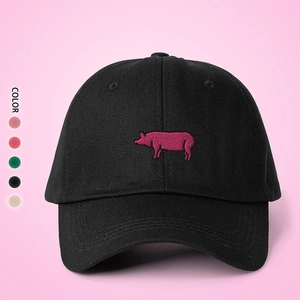 Close-up of pink pig embroidery on black cotton baseball cap with color options