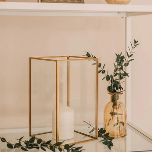 Modern minimalist gold metal frame glass candle holder with white pillar candle inside