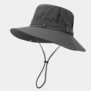 Detail view of dark grey outdoor sun hat with wide brim, side vents and windproof cord