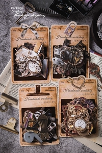 Macro shot of vintage style hollowed-out scrapbooking paper with clock and bow motifs