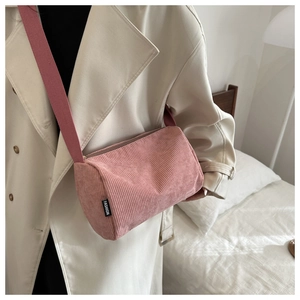 Detailed close-up of pink corduroy texture and Fashion tag on crossbody tote bag