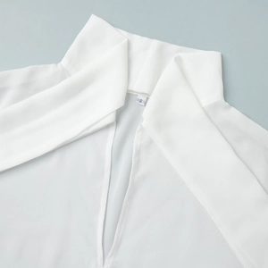 Detail shot of white chiffon blouse collar with V-neckline and elegant ribbon tie detail