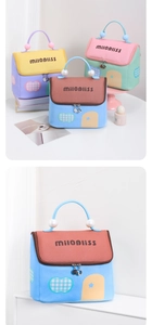 Detail of PU leather house-shaped makeup bag with pearl handle and color-blocking design