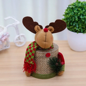 Creative Christmas reindeer candy jar with plush knitting and red checkered scarf on wood