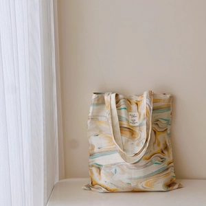 Minimalist canvas tote bag with abstract wood grain ink print and shoulder straps