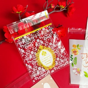 Cute cartoon bear self-adhesive packaging bags with floral patterns on a red background