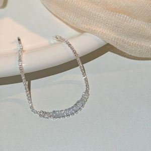 Close-up of silver bracelet with rectangular and round cut clear cubic zirconia stones