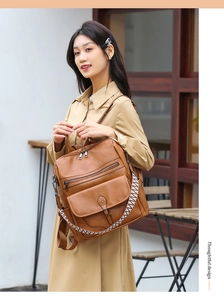 Close-up of vintage brown backpack showing front flap pocket and woven strap details