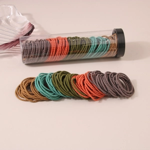 Set of multi-color high elasticity woven hair ties neatly organized in a transparent storage tube