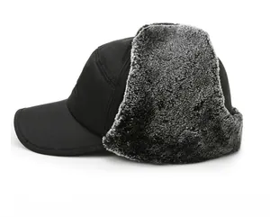 Vista laterale del cappello invernale nero con fodera in ecopelliccia grigia e paraorecchie