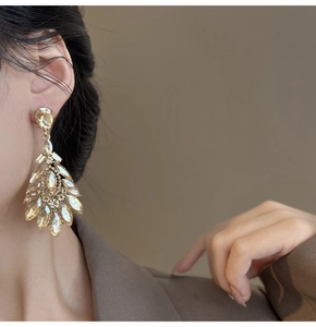 Macro side view of oversized teardrop earrings with champagne crystals and vintage design