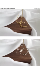 Macro detail of twisted S925 sterling silver hoop earrings in gold and silver finishes