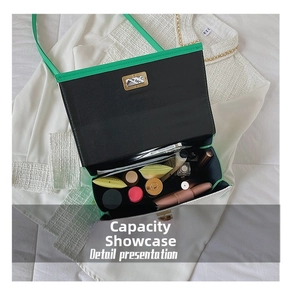 Detail presentation showing the spacious interior of a green crocodile pattern shoulder bag