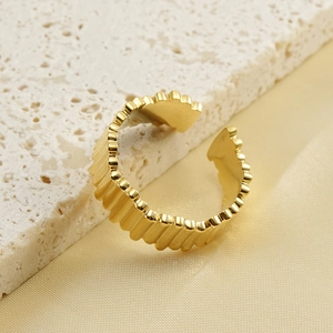 Irregular textured 18k gold plated stainless steel open ring on silk background