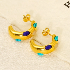 Close-up of golden stainless steel hoop earrings with turquoise and lapis lazuli stones