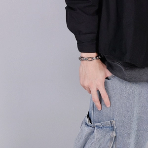 Close-up of vintage punk stainless steel chain bracelet worn on a male wrist
