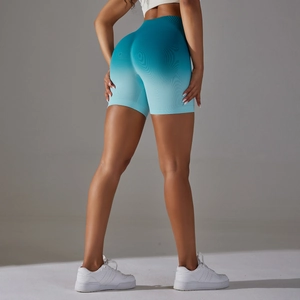 Rear view of seamless high-waist yoga shorts with teal gradient and peach butt lift effect