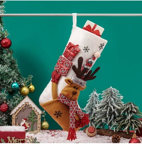 Detailed plush Christmas stocking featuring a 3D reindeer holding a red gift box