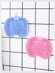 Close-up of pink silicone bath brush with dense soft bristles for wall-mounted back scrubbing