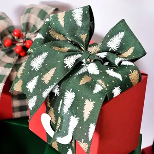 Dark green Christmas wired ribbon with gold pine trees tied into a gift bow