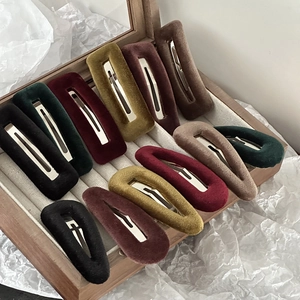 Set of colorful velvet rectangle and teardrop hair clips in a wooden jewelry box