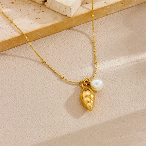 Gold plated stainless steel necklace featuring a delicate shell and pearl pendant on a bead chain